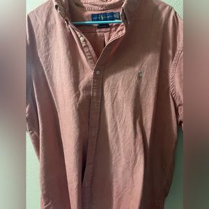 This is a light pink button up shirt